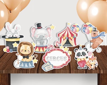 May include: A collection of circus-themed paper cutouts featuring a rabbit, elephant, lion, panda, bear, and fox. The cutouts include a circus tent, a sign that says "CIRCUS", and balloons. The color palette includes red, yellow, and blue.