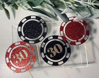 May include: Four black and red glitter casino chip cupcake toppers with gold numbers "30" on two of the toppers.