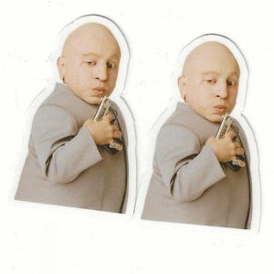 May include: Two stickers of a bald character in a grey suit, holding a small device. The character has a serious expression. The stickers are cut out with a white border, suitable for various applications.