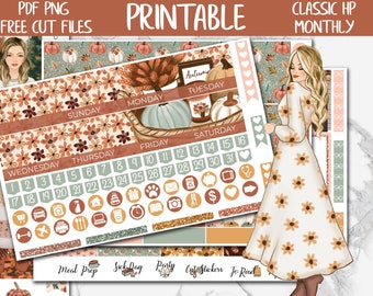 May include: Printable monthly planner stickers with a fall theme. The stickers feature a woman in a floral dress, pumpkins, leaves, and the words "Autumn" and "Tuesday".