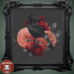 May include: A black raven perched on a bouquet of red and pink roses. The raven has a dark gray body and black eyes. The roses are arranged in a circular pattern around the raven.