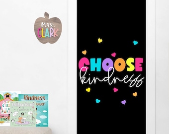 May include: A black door with the words "CHOOSE kindness" in colorful letters and small hearts scattered around the text. The door is decorated for a classroom.