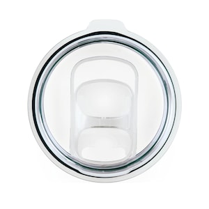May include: A clear plastic lid with a silver rim and a green rubber seal. The lid has a hole in the center with a smaller hole inside it.