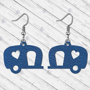 May include: A pair of blue camper earrings with a heart cutout. The earrings are made of leather and have silver hooks.
