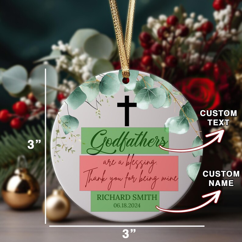 May include: A 3-inch round white ceramic ornament with a green and white floral design. The ornament features a green, white, and red banner with the text "Godfathers are a blessing. Thank you for being mine."  The ornament also includes a green banner with the text "RICHARD SMITH 06.18.2024".