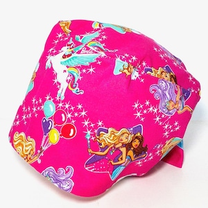 May include: Pink fabric headband with a colorful print featuring a unicorn, stars, and Barbie dolls. The headband has a tie closure.