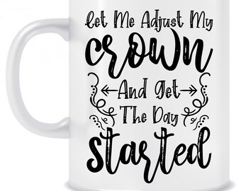 May include: White ceramic coffee mug with black text that reads "Let me adjust my crown and get the day started".