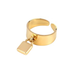 May include: A gold-colored adjustable ring with a rectangular padlock charm. The ring has a thick band and an open design. The padlock charm hangs from a small loop attached to the ring.