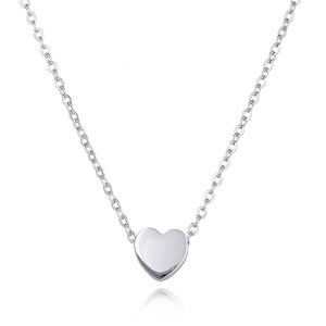 May include: A delicate silver chain necklace with a small, smooth heart pendant.
