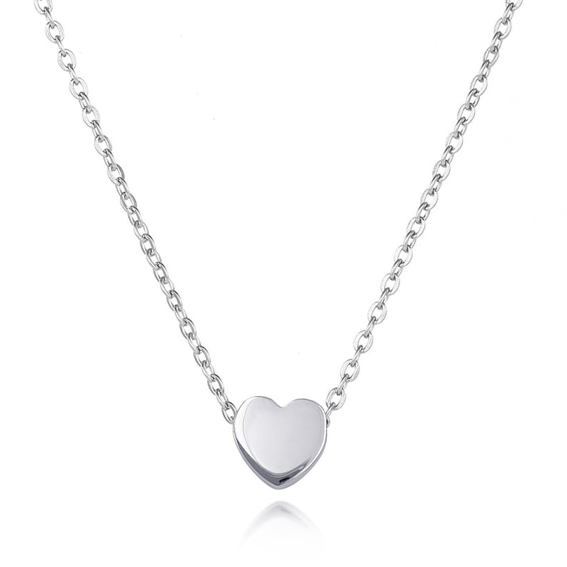 May include: A delicate silver chain necklace with a small, smooth heart pendant.