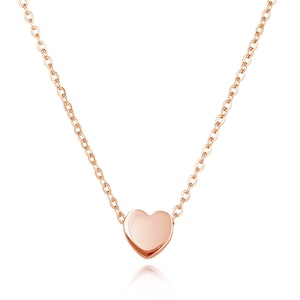 May include: A delicate rose gold necklace with a small heart pendant.