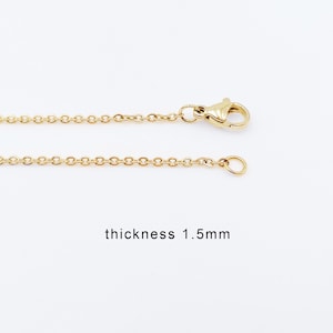 May include: A gold chain necklace with a lobster clasp and a jump ring. The chain is 1.5mm thick.