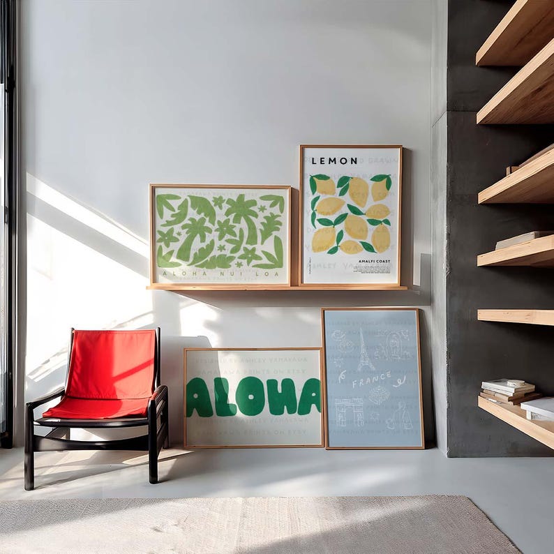 May include: Four framed prints on a white wall. The prints feature illustrations of lemons, palm trees, the word "ALOHA" and a stylized Eiffel Tower. The prints are arranged in a grid pattern.