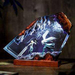 May include: A decorative resin sculpture featuring a battle scene with two figures, one holding a large sword. The sculpture is encased in a clear resin with a wooden base and accents. The resin has a blue and brown marbled effect.