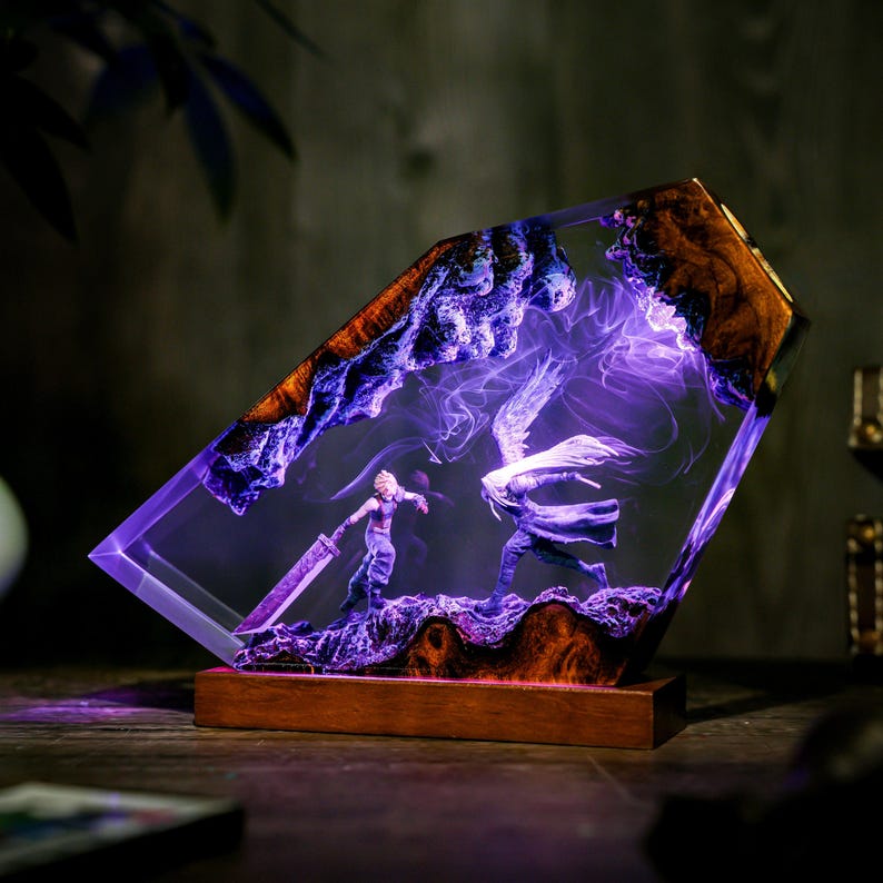 May include: A decorative resin lamp featuring a battle scene with two figures, illuminated by purple light. The lamp has a wooden base and is encased in a clear, angled resin block with wood and purple accents.