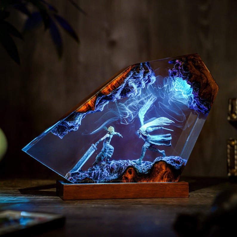 May include: A decorative resin sculpture featuring two figures in combat, set within a clear, angled block. The sculpture has a wooden base and is illuminated with blue and white light, with wood grain accents.