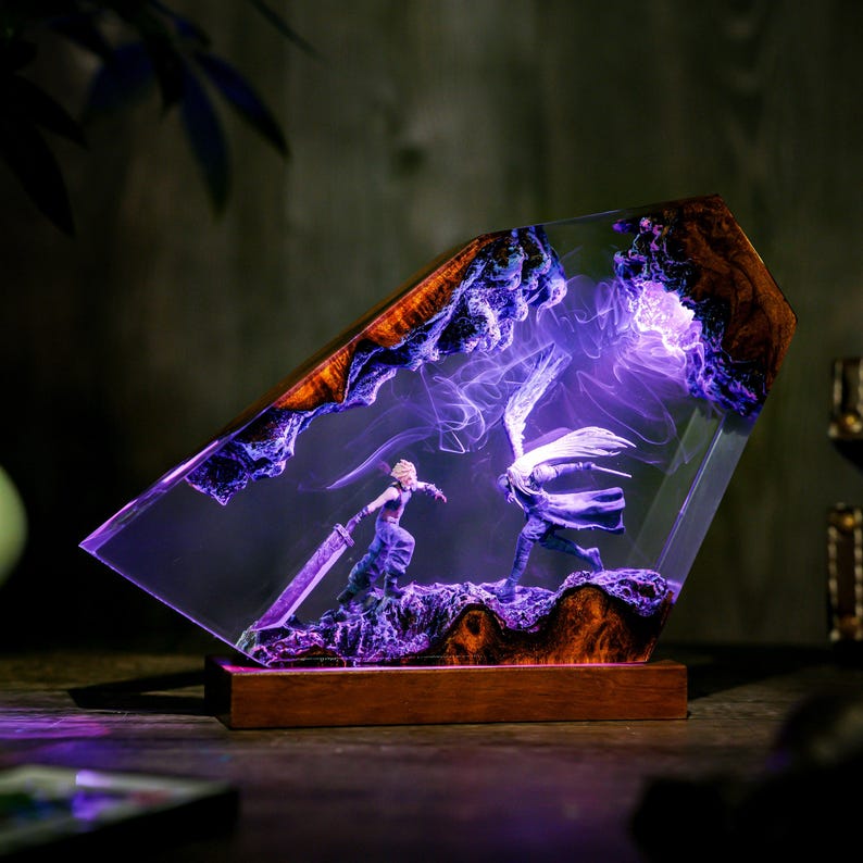 May include: A decorative resin lamp featuring a battle scene with two figures, illuminated by purple light. The lamp has a wooden base and a geometric shape with a wooden frame. The figures are set against a backdrop of swirling purple smoke.