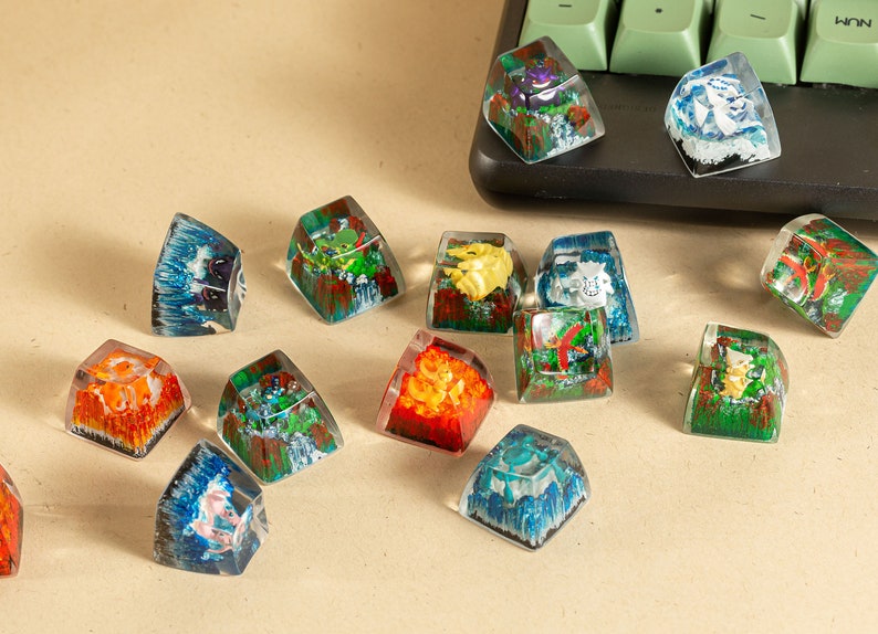 May include: A collection of 12 colorful resin keycaps featuring various nature-inspired designs. Each keycap is a unique piece of art with intricate details and vibrant colors. The keycaps are perfect for adding a touch of personality to any keyboard.
