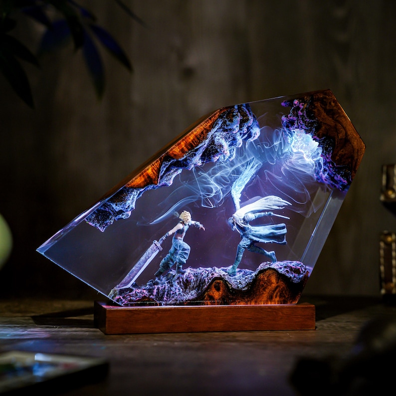 May include: A decorative resin sculpture featuring a battle scene with two figures, set within a clear, angled block. The sculpture has a wooden base and the resin is accented with blue and purple hues, creating a dynamic and artistic display.