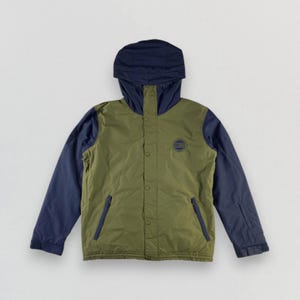May include: Olive green and navy blue hooded jacket. The jacket has a navy blue hood and sleeves, with an olive green body. It features a button-up front, two front pockets, and a small circular emblem on the chest.