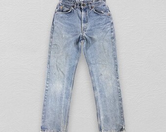 May include: Light blue denim jeans with a faded look and frayed hems.