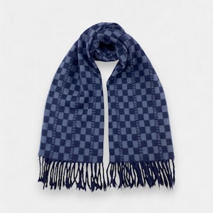 May include: A navy blue scarf with a checkered pattern and fringe. The scarf features the brand name in a repeating pattern across the fabric. The scarf is made of a soft material and is suitable for cold weather.