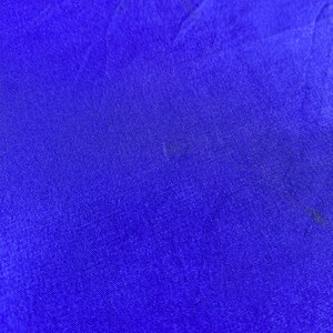 May include: A solid blue fabric with a smooth, slightly textured surface.