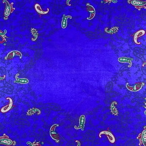 May include: A blue fabric background with a paisley pattern. The paisley pattern is in shades of green, red, and white.