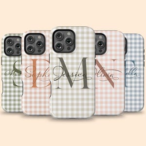 May include: Five smartphone cases featuring a gingham check pattern in various muted colors. Each case displays a large, semi-transparent capital letter overlaid with a cursive name, including Mad, Sophie, Jessica, Olivia, and Bella.