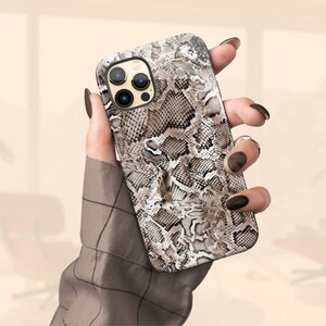 a woman holding a phone case in her hand