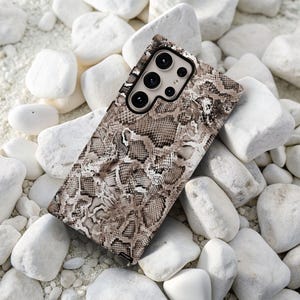 a close up of a cell phone on a pile of rocks