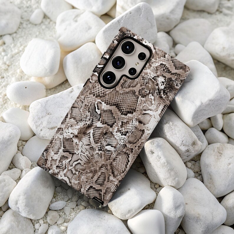 a close up of a cell phone on a pile of rocks