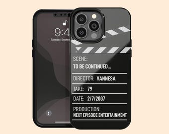 May include: A black smartphone case featuring a white film clapperboard design with the text SCENE: TO BE CONTINUED..., DIRECTOR: VANNESA, TAKE: 79, DATE: 2/7/2007, and PRODUCTION: NEXT EPISODE ENTERTAINMENT printed in white on the back of the device.