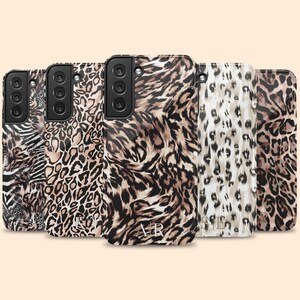 May include: Five different phone cases with a leopard print design. The cases are all black and brown with a white background. The cases have different patterns and designs. The cases are all for the same phone model.