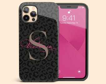 May include: A black and grey leopard print phone case featuring a large beige letter S and the name Victoria in pink cursive script. The case is shown on a smartphone displaying a pink screen with the time 9:41 and the date Tuesday, September 10.