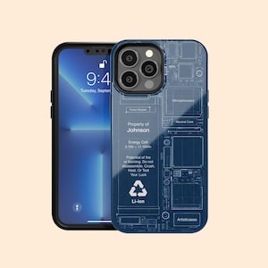 May include: A blue phone case with a circuit board design, next to a black smartphone. The case has the text "Property of Johnson", "Energy Cell 3.79V-11.16Wh", and safety warnings. The phone screen displays the time 9:41.