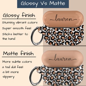 May include: Two Airpod cases with a leopard print design. The top case is glossy and the bottom case is matte. Both cases have the name "lauren" written on the top.