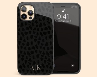May include: A black smartphone case featuring a dark gray leopard print pattern and the initials AK centered at the bottom. The case is shown on a smartphone displaying a lock screen with the time 9:41 and the date Tuesday, September 10.