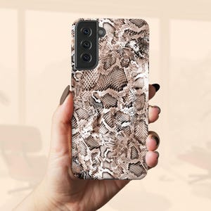 a woman holding a phone case in her hand