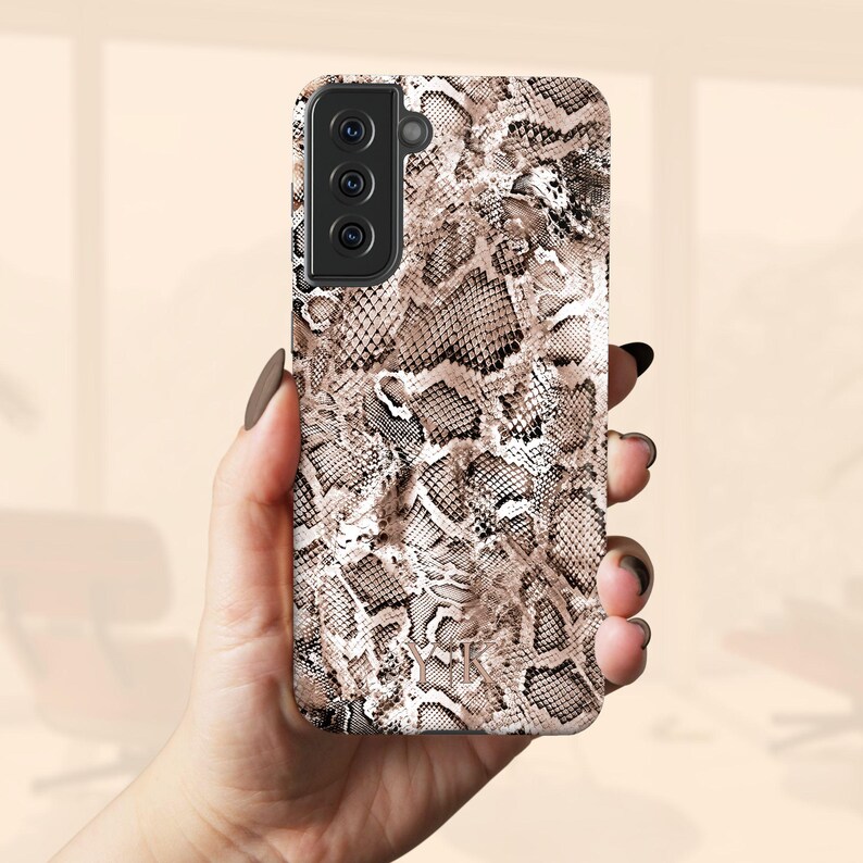 a woman holding a phone case in her hand