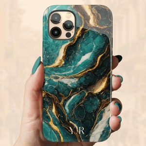 May include: A green and gold marble phone case with the initials "YR" printed on the back.