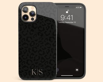 May include: A black smartphone case featuring a dark gray leopard print pattern and the letters K|S in a serif font at the bottom. The case is shown on a smartphone displaying a lock screen with the time 9:41 and the date Tuesday, September 10.