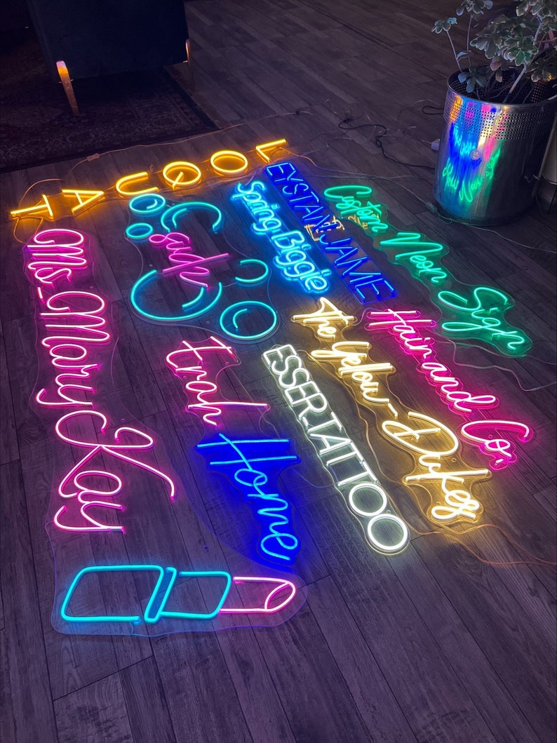 May include: A collection of neon signs with various phrases and designs, including "Cool", "Sparkle", "The Home", "Miss Mary Kay", "Custom Neon", "Hair and Co", "Esser Tattoo", "To Your Dufeg", "Spring Boggle", "Leystate Jame", and "Taco".