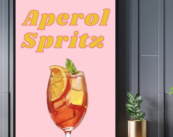 Pode incluir: Um cartaz rosa com o texto "Aperol Spritz" em letras amarelas e rosas. Um copo de Aperol Spritz com uma fatia de laranja e um ramo de hortelã é ilustrado no cartaz.