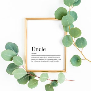 May include: A framed print with a gold frame and a white background. The print features the word "Uncle" in black text with the definition: "Someone who helps you get into mischief that you haven't even thought of yet. A man who is like a Dad but without the discipline and a whole lot cooler."