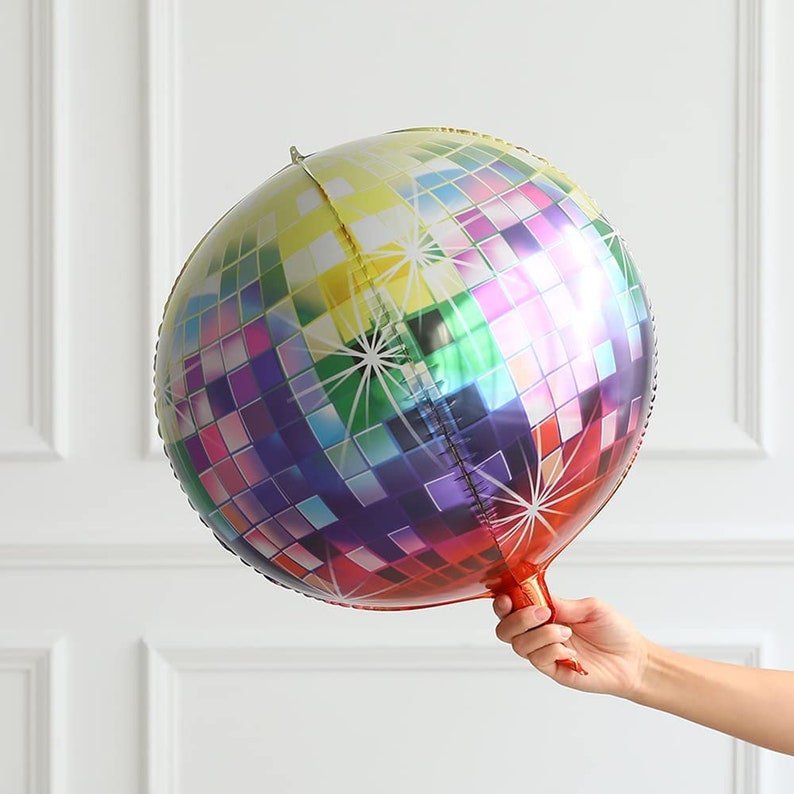 May include: A large, round, iridescent disco ball balloon with a rainbow pattern. The balloon is made of mylar and has a self-sealing valve.