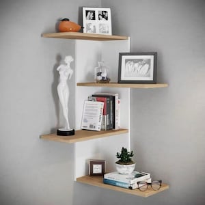 May include: A modern corner shelf unit with four wooden shelves and a white backing. The shelves display decorative items like a statue, framed photos, books, a small clock, and a potted plant. The unit is mounted on a gray wall.