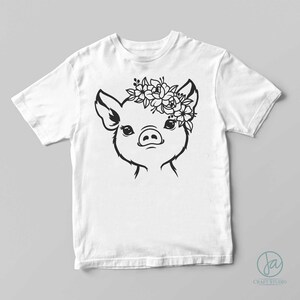 May include: A black and white illustration of a pig wearing a floral crown. The pig is looking directly at the viewer. The image is on a white t-shirt.
