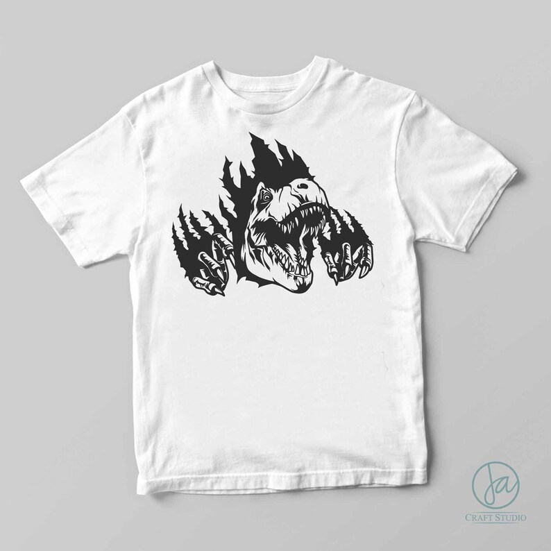 May include: A white t-shirt with a black graphic of a dinosaur head breaking through the fabric. The dinosaur is roaring with its mouth open and its claws are visible.