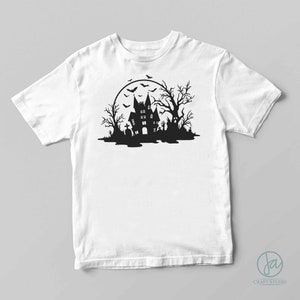 May include: A white t-shirt with a black silhouette of a haunted house, trees, and bats in front of a full moon.